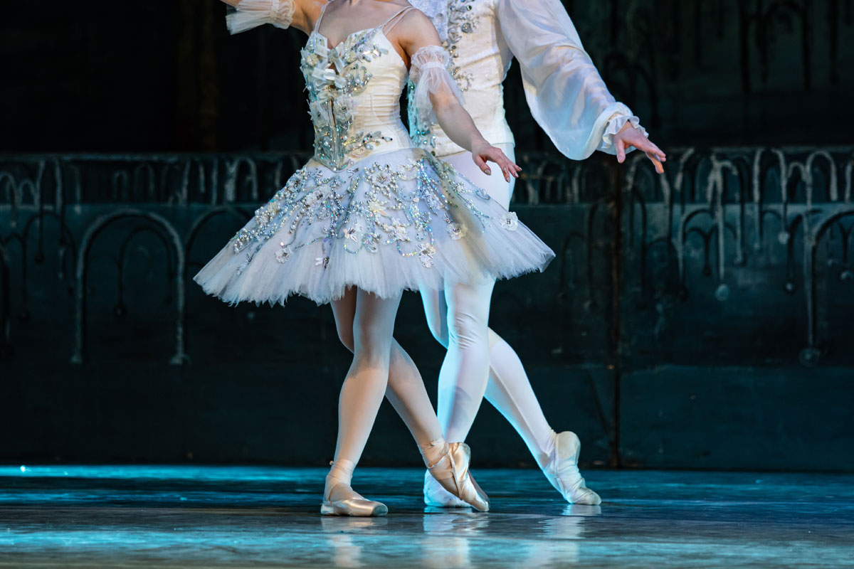Ballet concert - Group of ballerinas dancing while raising both hands